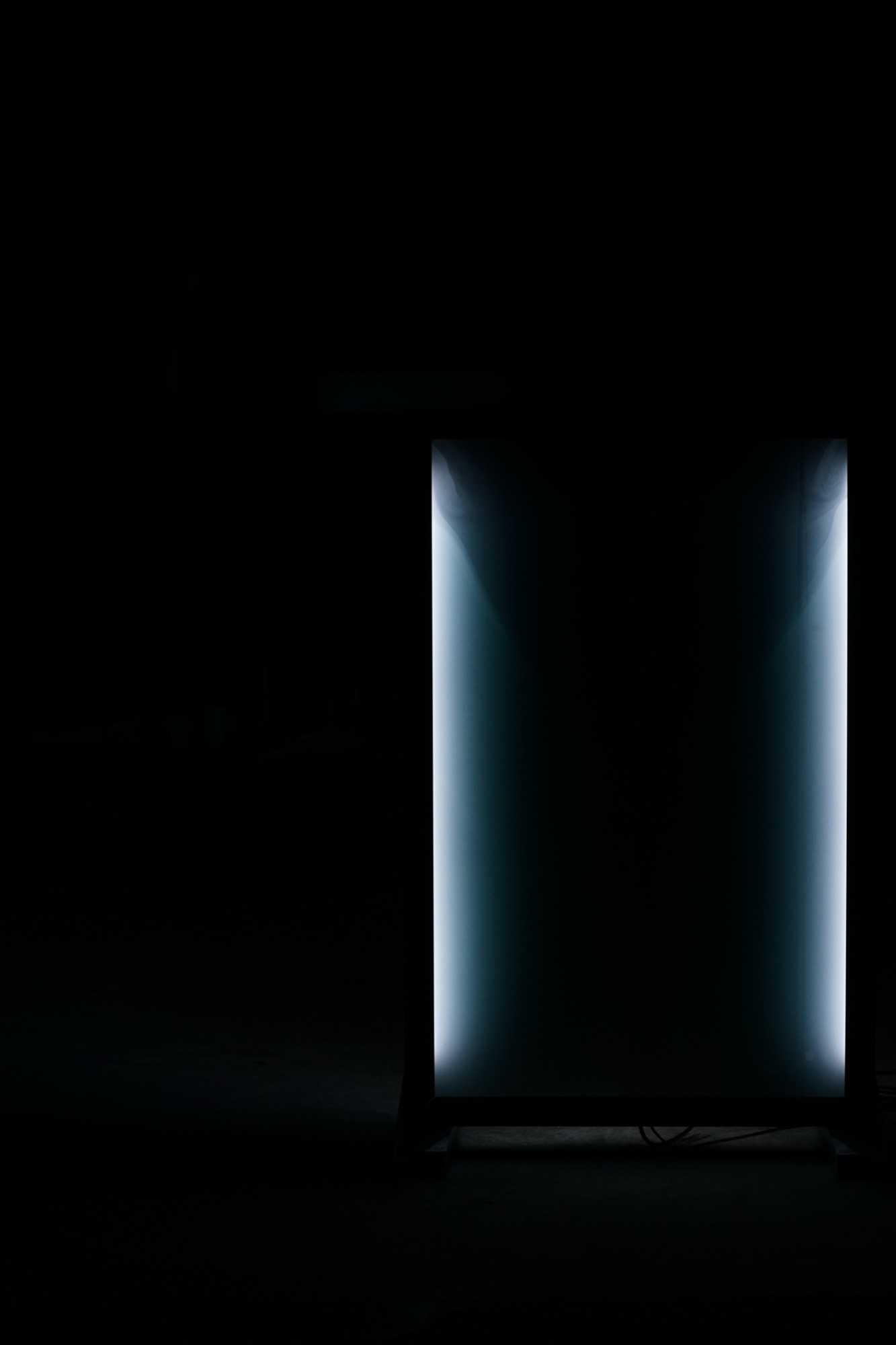 cloud chamber — illuminated fog inside a glass volume